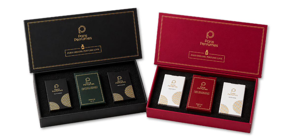 Dve otvorené darčekové krabičky Paris Perfumes, čierna a bordová, každá s tromi flakónmi